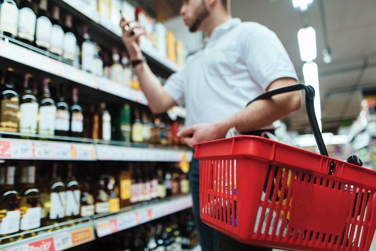 A,Buyer,With,A,Red,Wine,Basket,Chooses,Wine,In